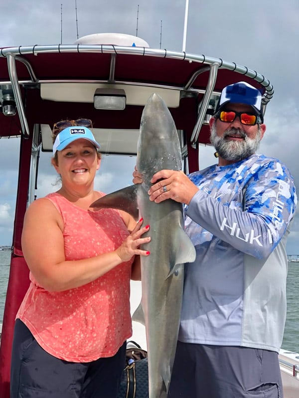 Husband and wife with large shark pulled in from Charleston Harbor