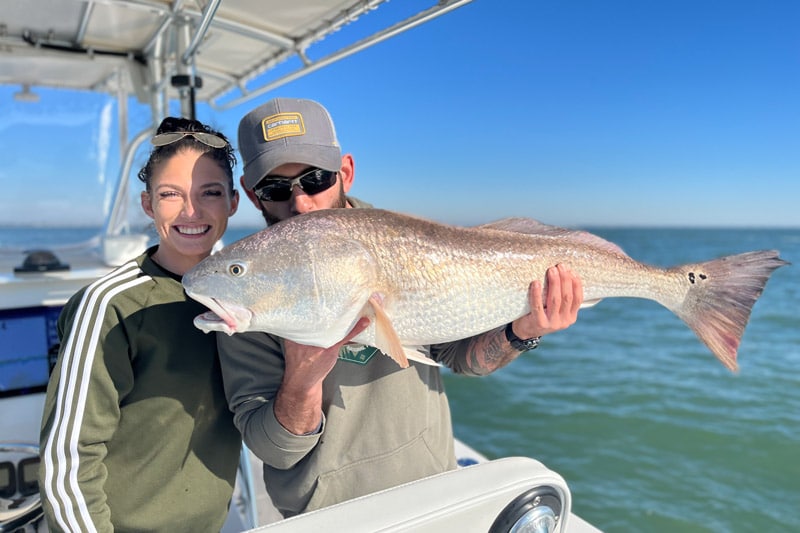 Husband and wife with large spottail bass during Charleston fishing charter