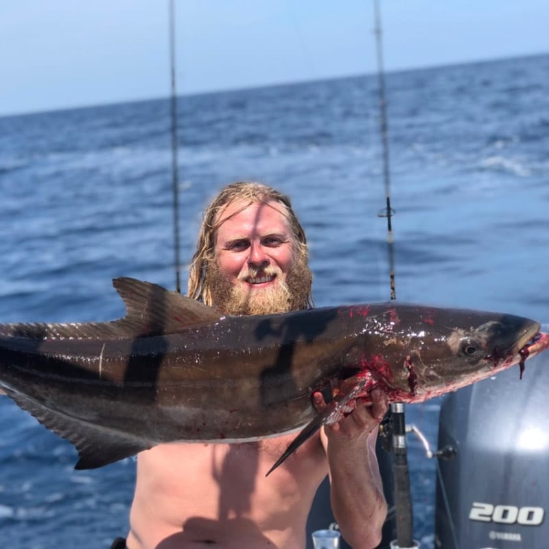 Man holding large cobia after nearshore fishing trip in Charleston